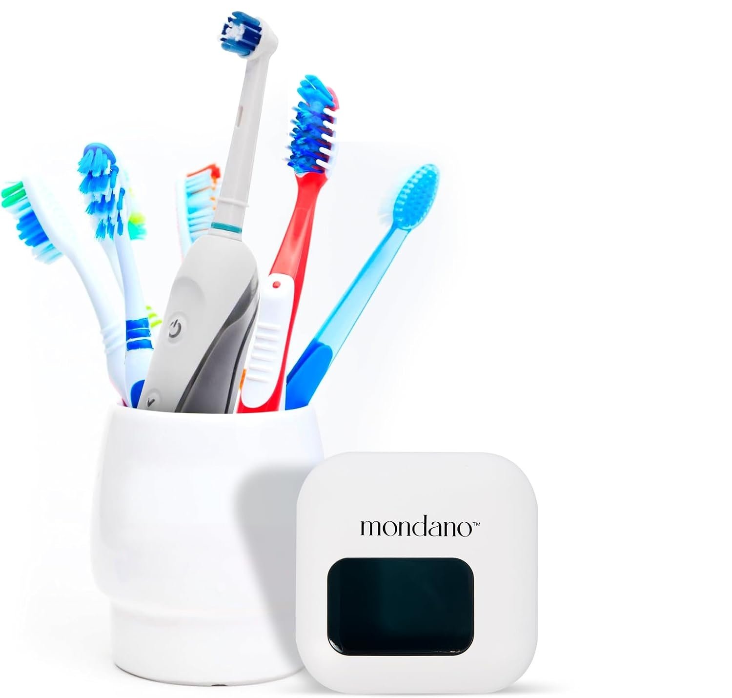 A cup of open toothbrushes on a bathroom counter